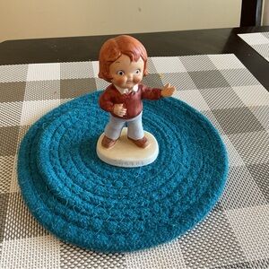 Adorable Child Figurine on Blue Mat